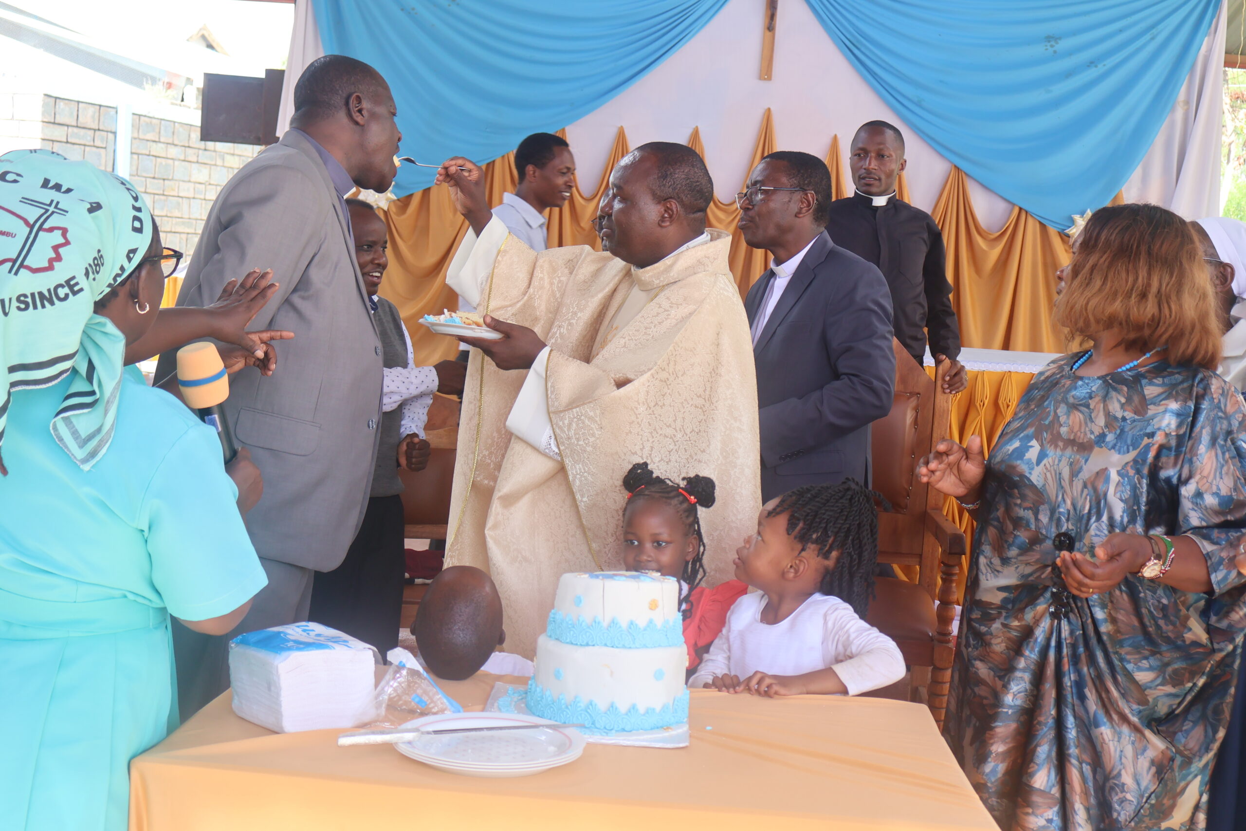 Diocesan Communications Coordinator & Kimuri FM Director Rev. Fr. James Gatiti shares a cake during his Silver Jubilee (25 years) Celebrations at Iriamurai parish on 20th December 2025.