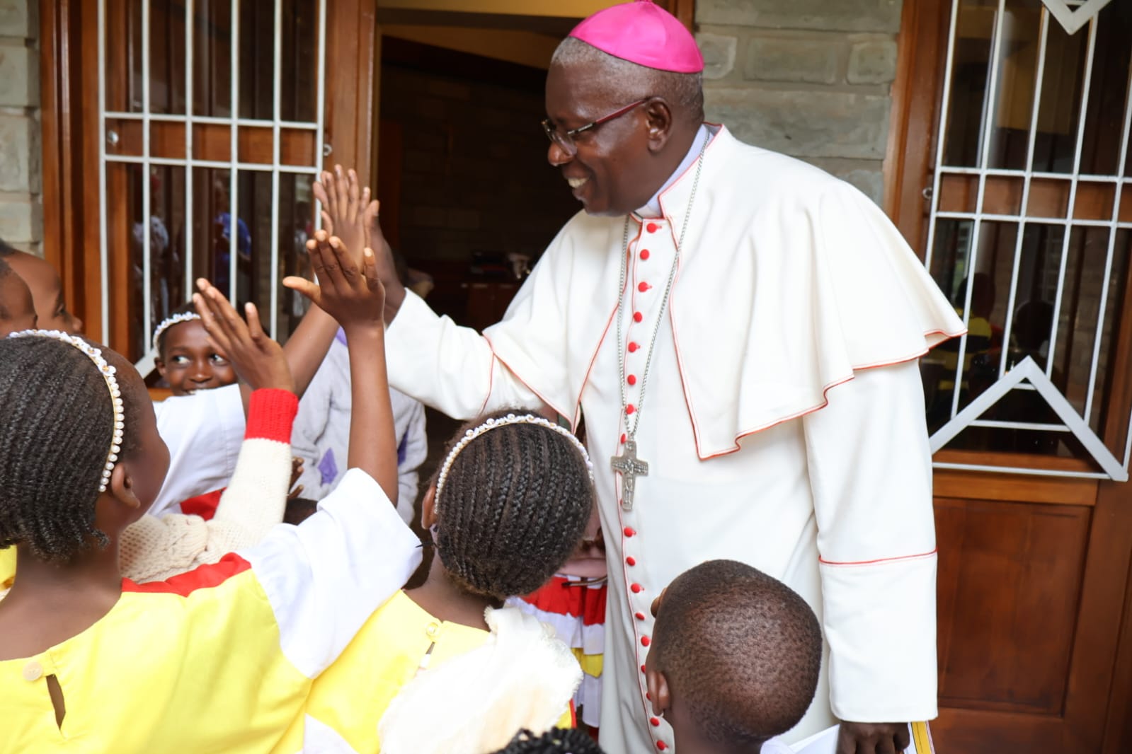 Diocese of Embu Bishop Peter Kimani Ndung'u engages children after holy mass at Ss. Peter & Paul Cathedral on 17th May 2026
